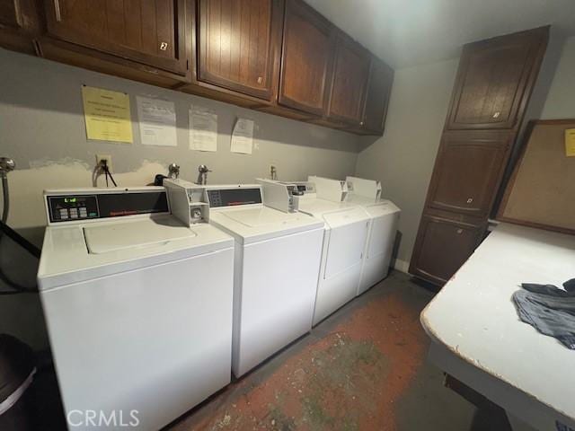 laundry room with washing machine and clothes dryer and cabinet space