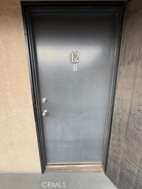 785 W 19th St Unit 12B, San Pedro, CA 90731 - doorway to property with stucco siding