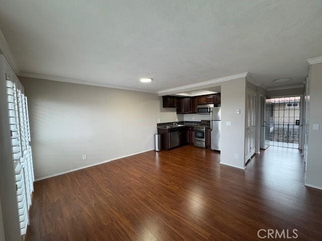 unfurnished living room with dark wood-type flooring, crown molding, and baseboards