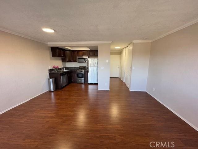 785 W 19th St Unit 12B, San Pedro, CA 90731 - kitchen featuring appliances with stainless steel finishes, dark brown cabinetry, dark wood-style floors, ornamental molding, and dark countertops
