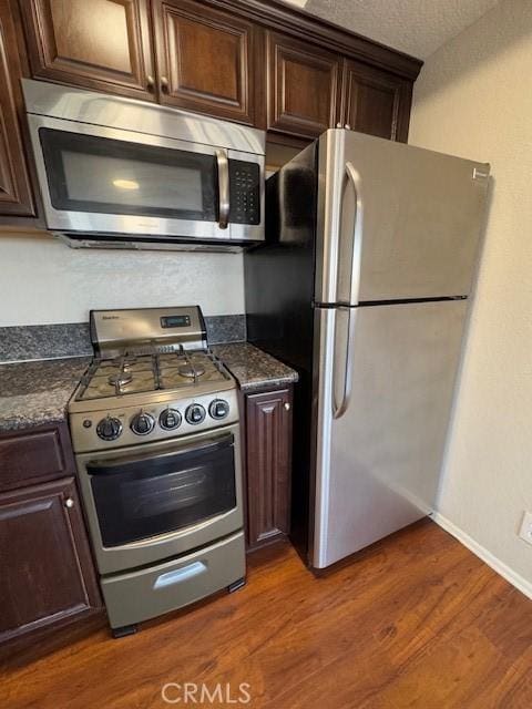 785 W 19th St Unit 12B, San Pedro, CA 90731 - kitchen with appliances with stainless steel finishes, dark countertops, and dark brown cabinets