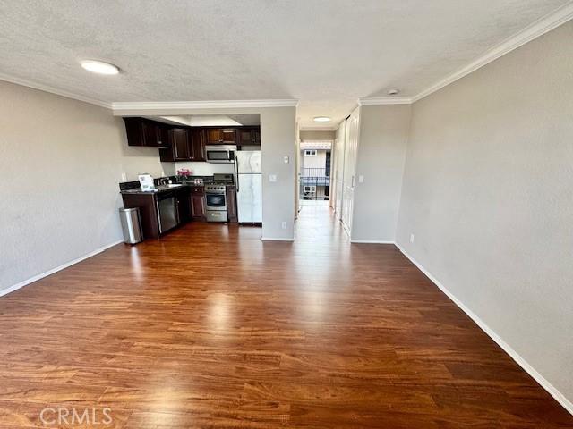 785 W 19th St Unit 12B, San Pedro, CA 90731 - unfurnished living room with dark wood finished floors and ornamental molding
