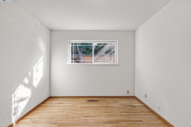 unfurnished room with light wood-type flooring