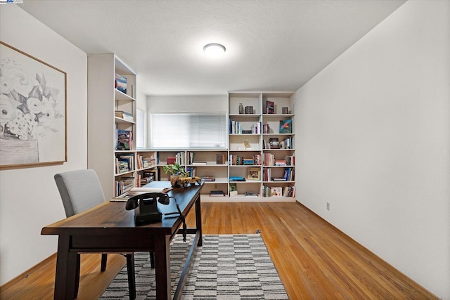 office area with light hardwood / wood-style floors