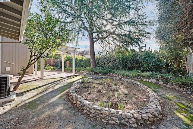 view of yard featuring a pergola and central AC