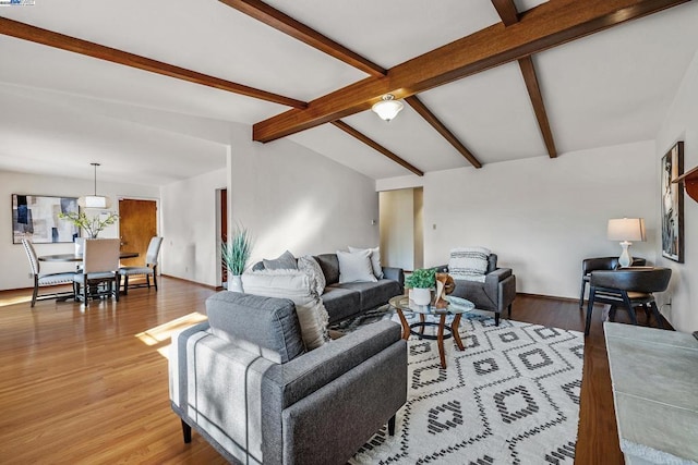 living room featuring hardwood / wood-style floors and lofted ceiling with beams