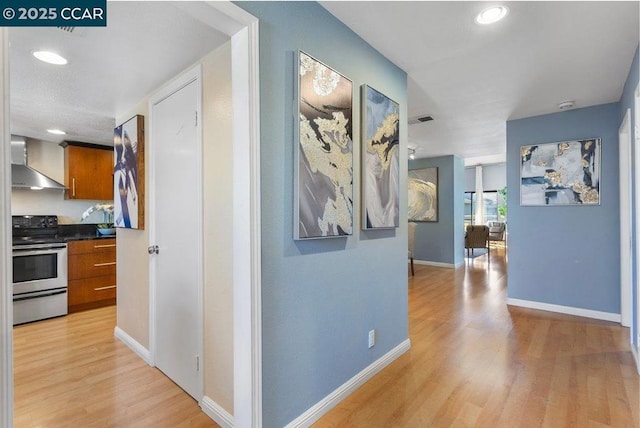 hallway with light hardwood / wood-style floors