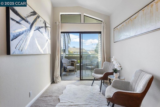 sitting room featuring lofted ceiling and carpet floors