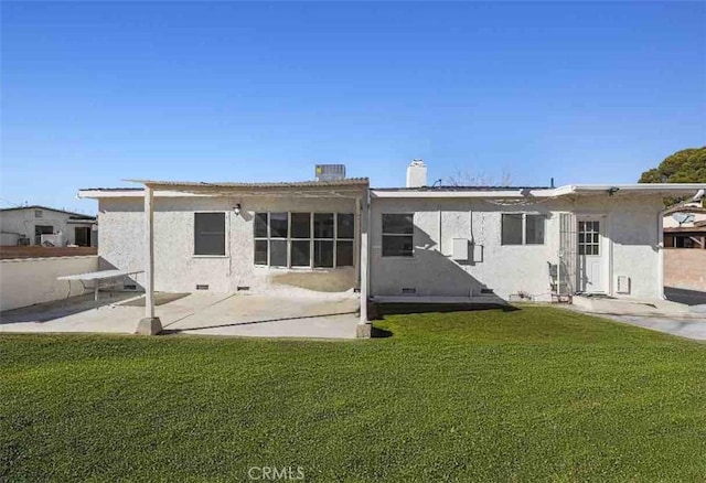 rear view of house featuring a patio, cooling unit, and a lawn