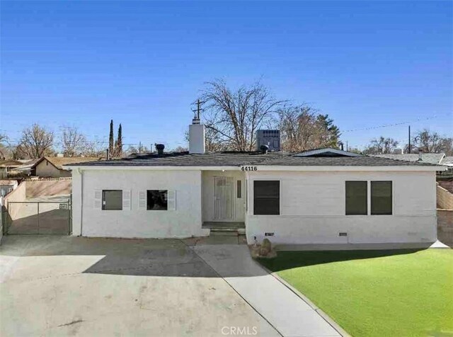 ranch-style home with a front lawn