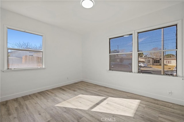 unfurnished room with light hardwood / wood-style floors