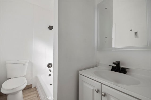 full bathroom with bathtub / shower combination, vanity, toilet, and wood-type flooring