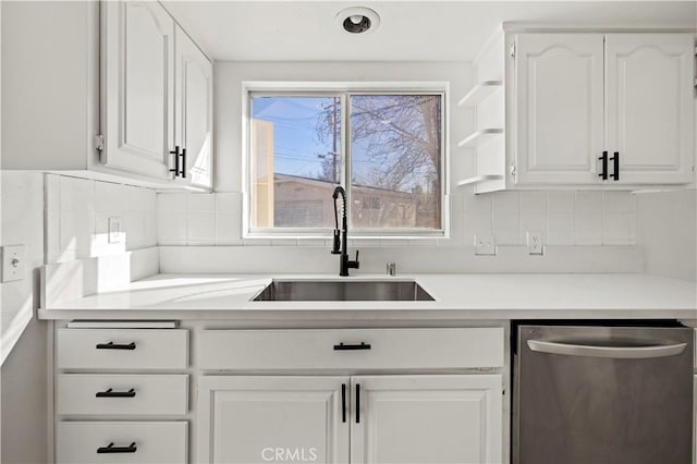 kitchen featuring sink, decorative backsplash, dishwasher, and white cabinets