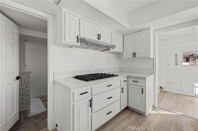 kitchen with white cabinetry, light hardwood / wood-style floors, and stainless steel gas cooktop