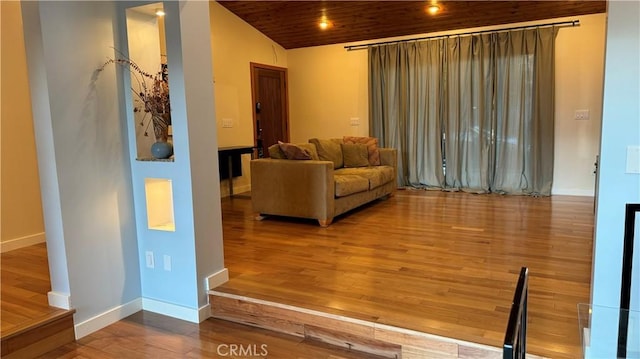 living room with hardwood / wood-style flooring, wooden ceiling, and vaulted ceiling