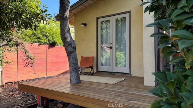 property entrance featuring a deck and french doors