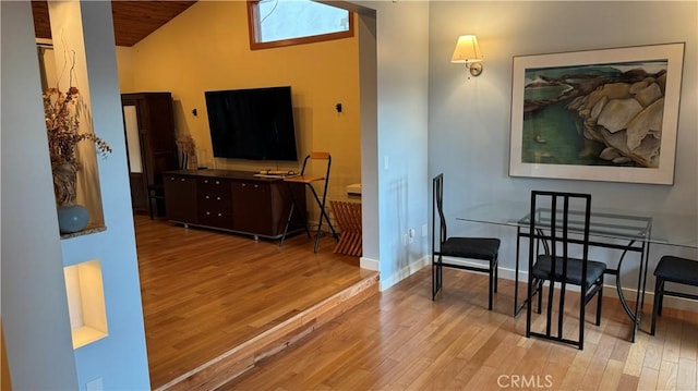 living area featuring wooden ceiling, light wood-type flooring, and vaulted ceiling