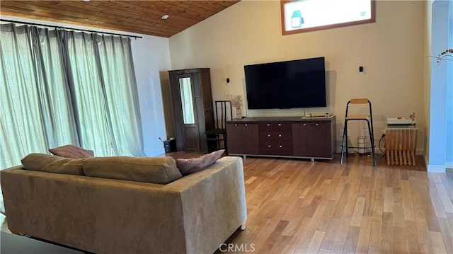 living room featuring wood ceiling, light wood-type flooring, high vaulted ceiling, and plenty of natural light