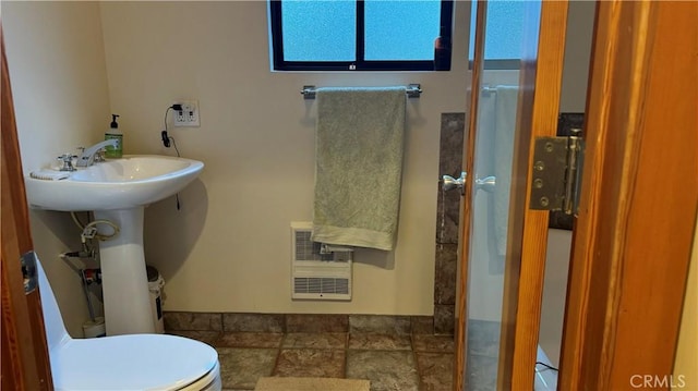 bathroom with toilet and heating unit