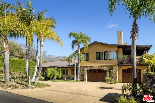 view of front of house featuring a mountain view and a garage