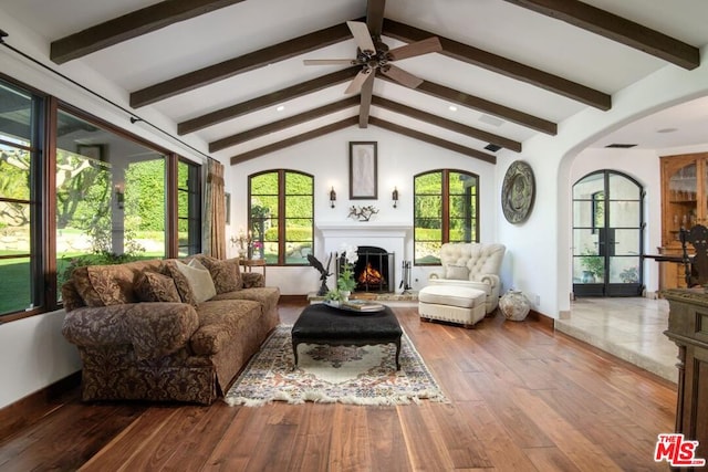 sunroom / solarium featuring lofted ceiling with beams