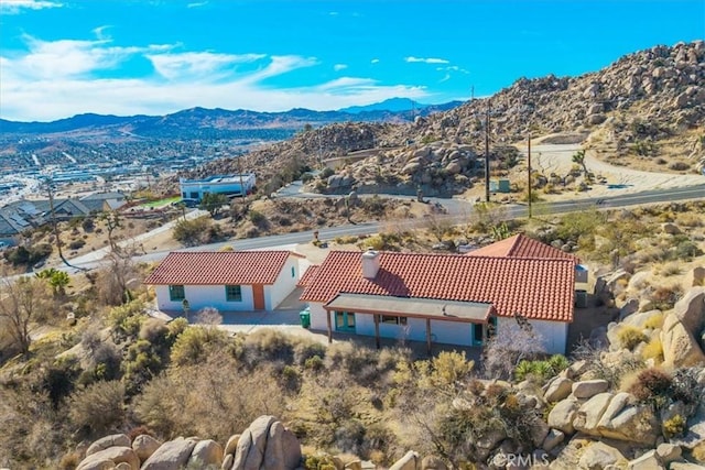 birds eye view of property with a mountain view