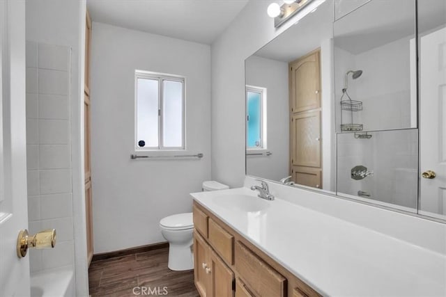 bathroom featuring toilet, vanity, and wood-type flooring