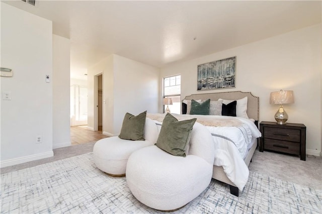 bedroom featuring light colored carpet