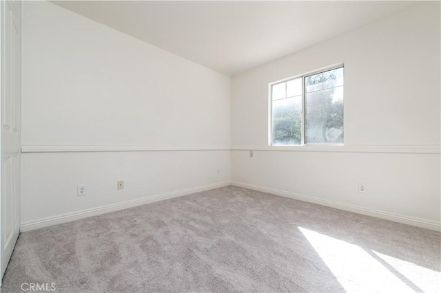 spare room featuring light colored carpet