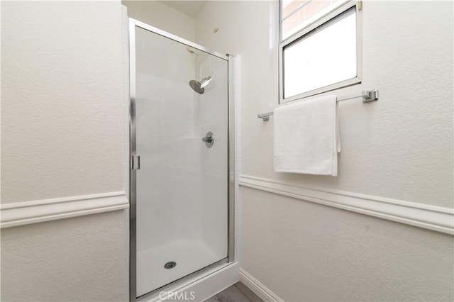 bathroom with a shower with door