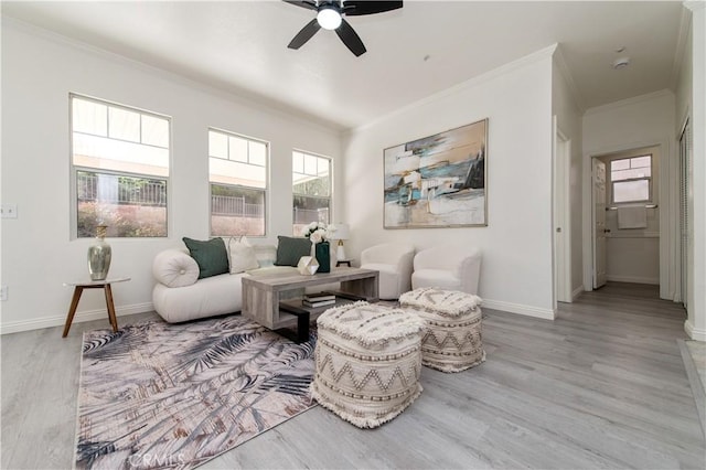 living room with ceiling fan, light wood-type flooring, and ornamental molding