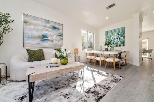 interior space featuring wood-type flooring and crown molding