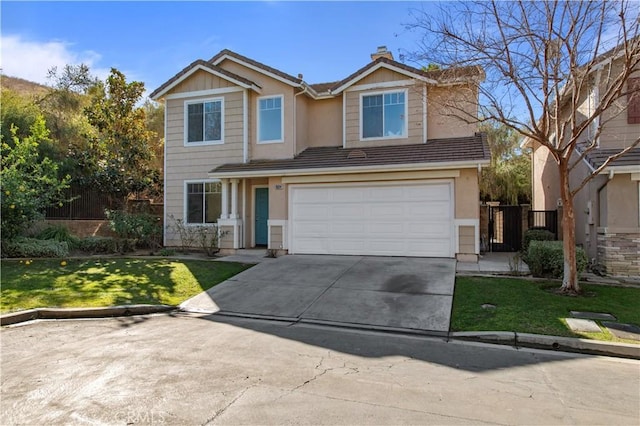 view of front of home with a front lawn and a garage