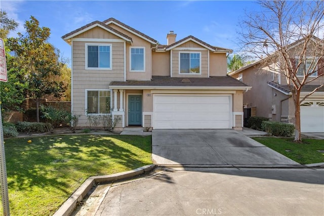 view of front of property with a front yard and a garage