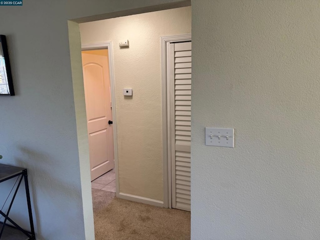 hallway with light colored carpet