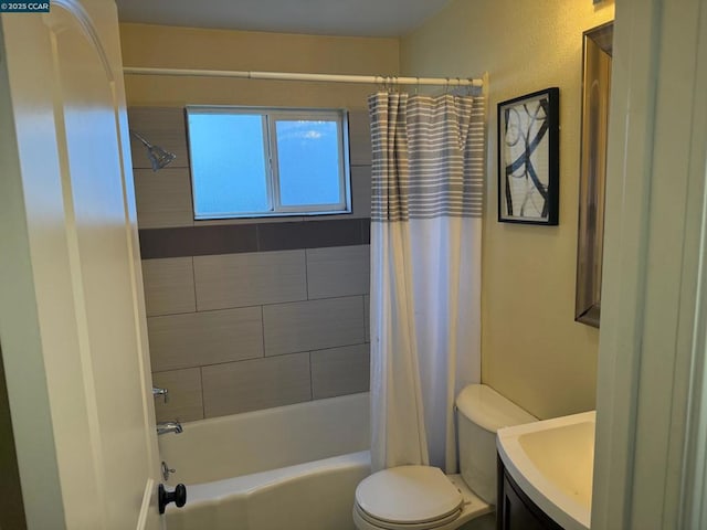 full bathroom with vanity, shower / tub combo with curtain, and toilet