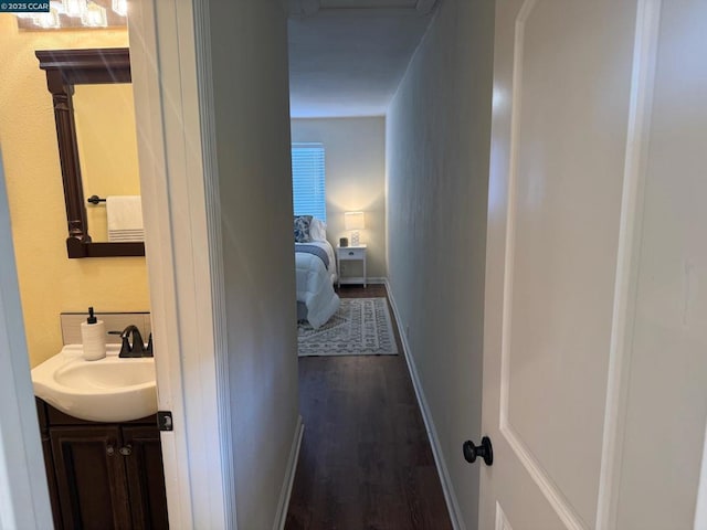 hallway featuring sink and dark hardwood / wood-style floors