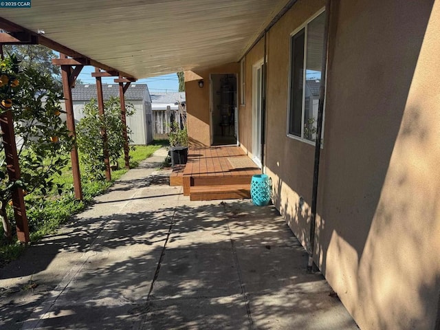 view of patio with a storage shed