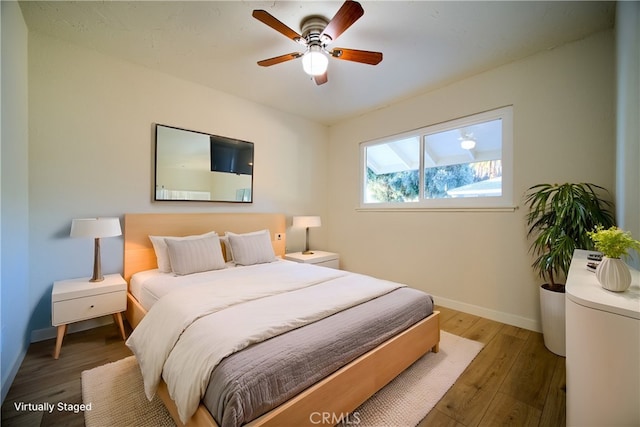 bedroom with dark wood-type flooring and ceiling fan