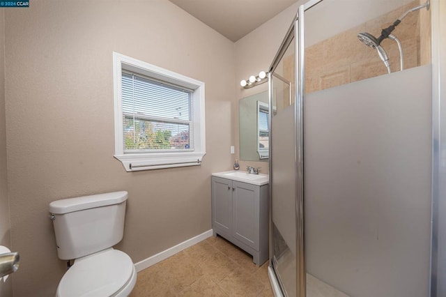 bathroom with vanity, toilet, tile patterned floors, and a shower with door