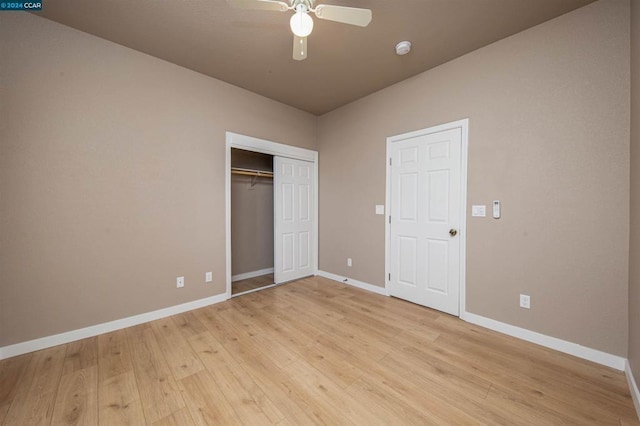 unfurnished bedroom with ceiling fan, a closet, and light hardwood / wood-style floors