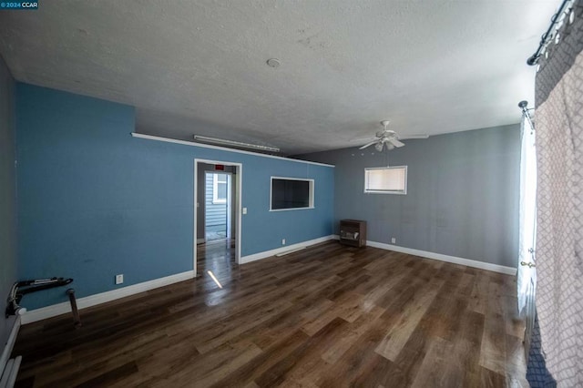 spare room featuring a textured ceiling, ceiling fan, and dark hardwood / wood-style floors