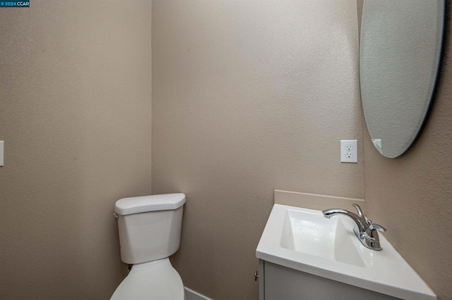 bathroom with toilet and vanity