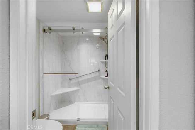 bathroom with a marble finish shower