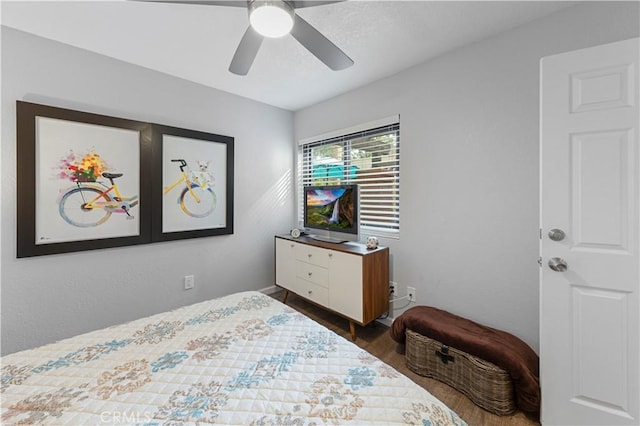 bedroom with dark wood-style flooring and ceiling fan