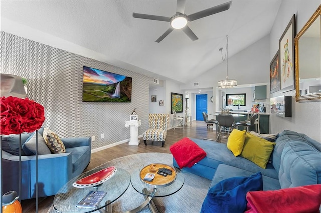 living area with dark wood-style floors, visible vents, an accent wall, baseboards, and wallpapered walls