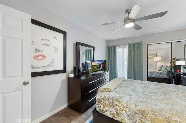 carpeted bedroom with ceiling fan and baseboards