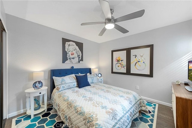 bedroom featuring dark wood-style floors, ceiling fan, and baseboards