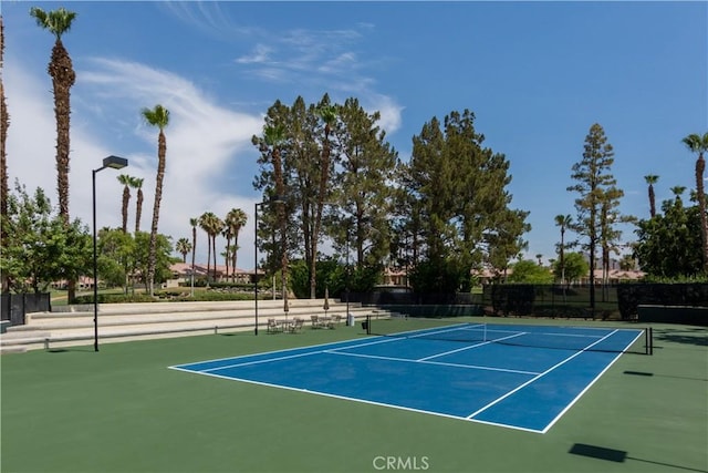 view of sport court featuring fence