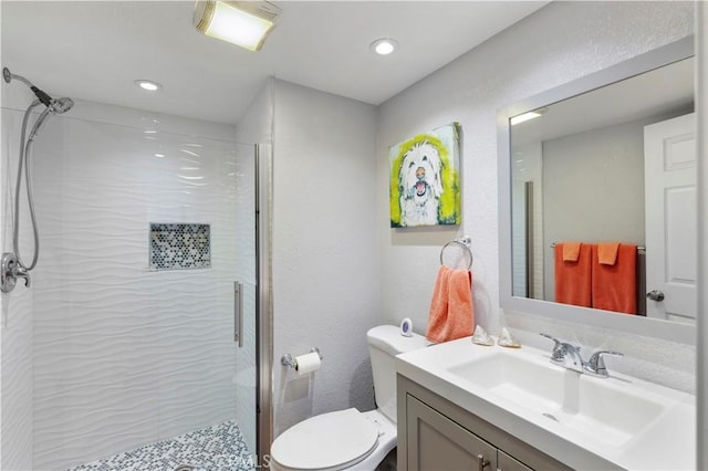 full bath with recessed lighting, toilet, vanity, and a shower stall